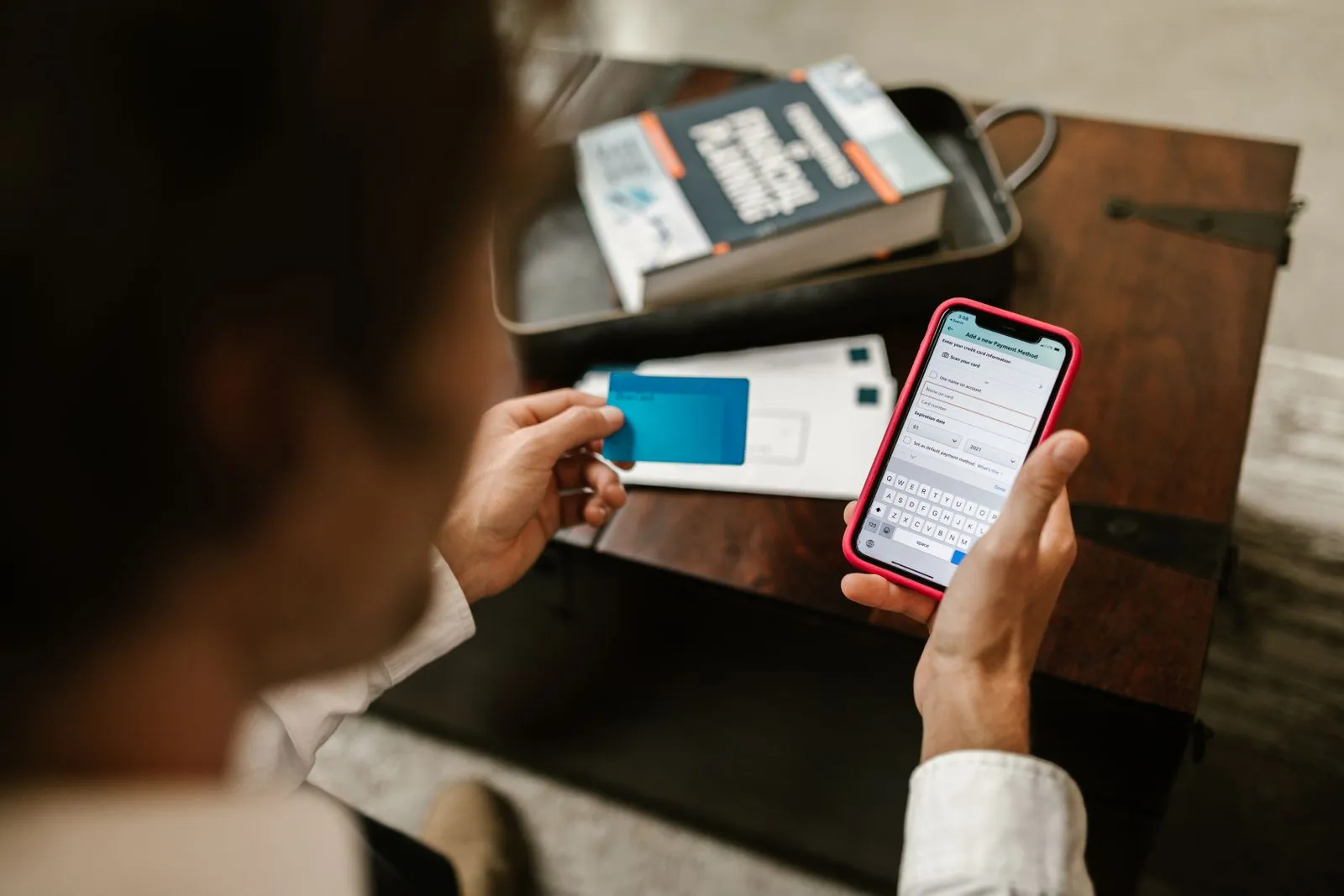 Person entering card details to pay a bill on a phone