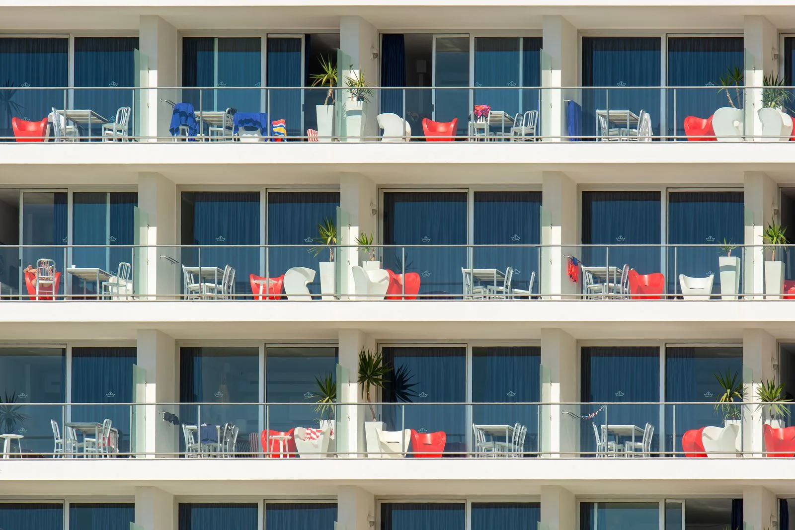 Rows of identical balconies on the face of a large resort apartment block